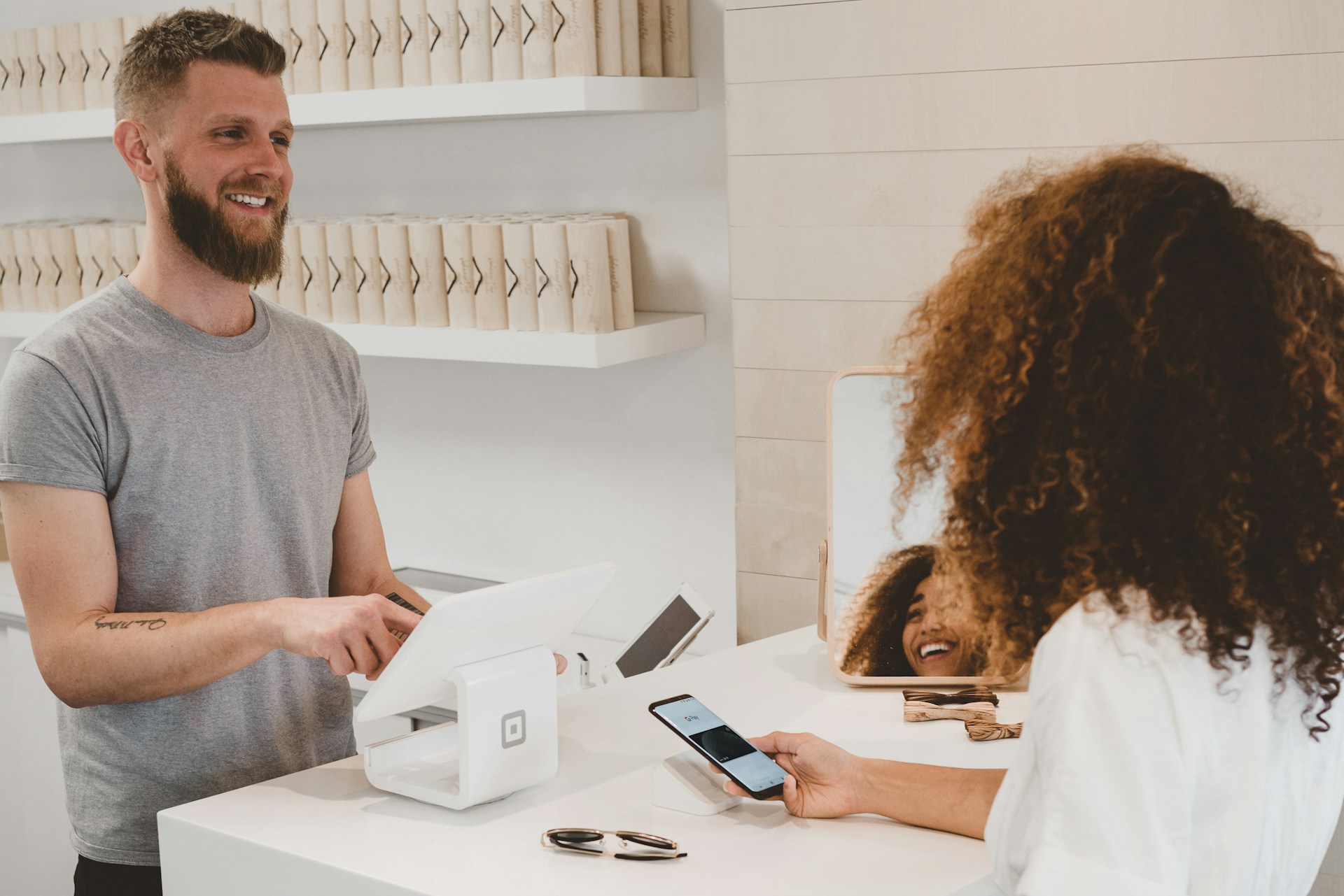 Retail checkout counter with card terminal and shopping bags